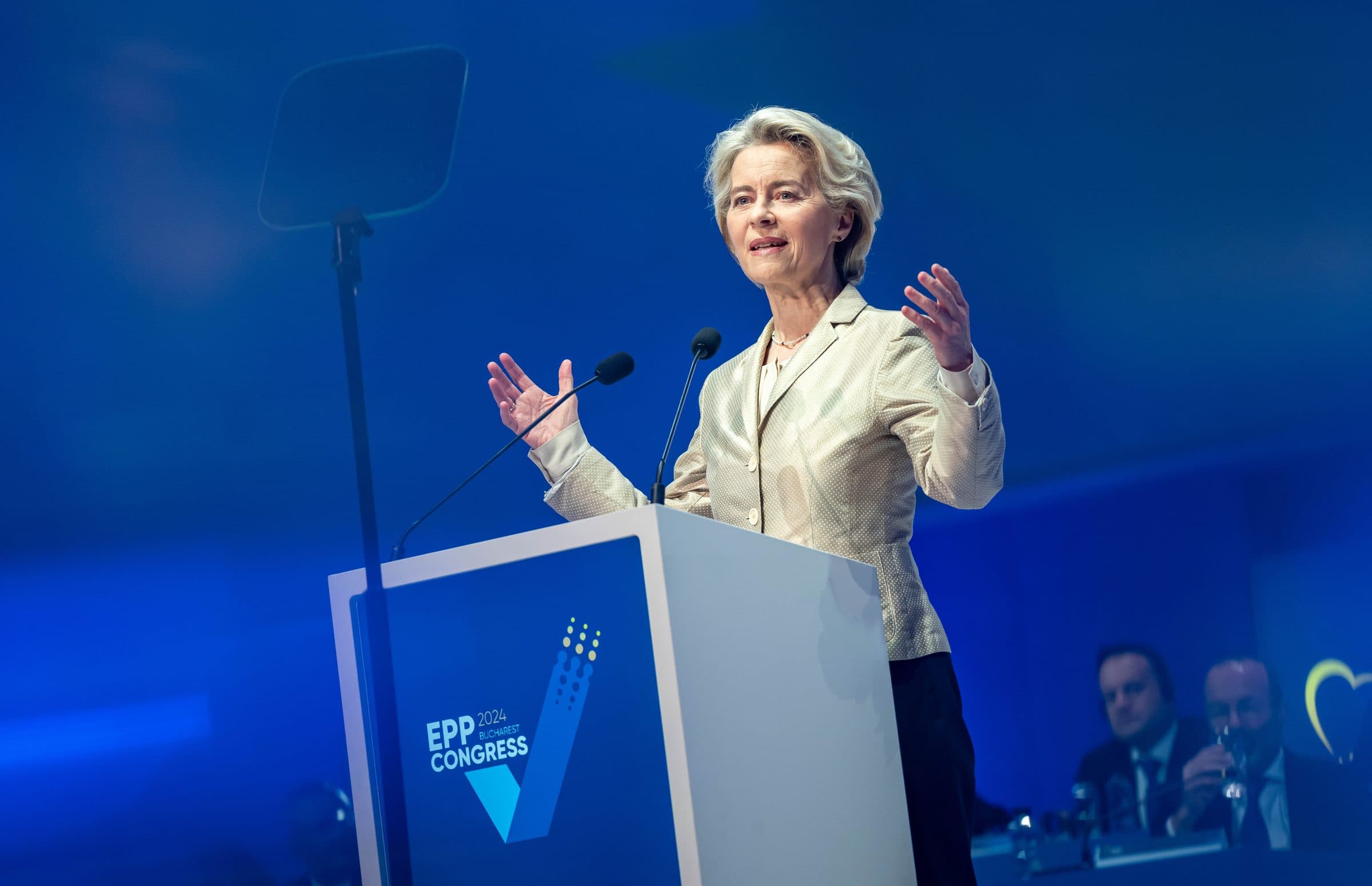 Ursula von der Leyen speaking at the lectern of the 2024 EPP Congress in Bucharest against a blue stage backdrop