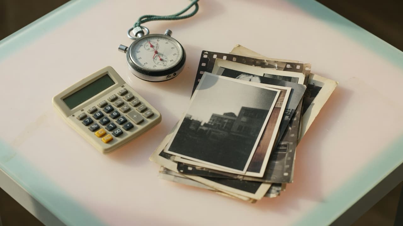 A calculator and a stopwatch next to a stack of prints on a light table
