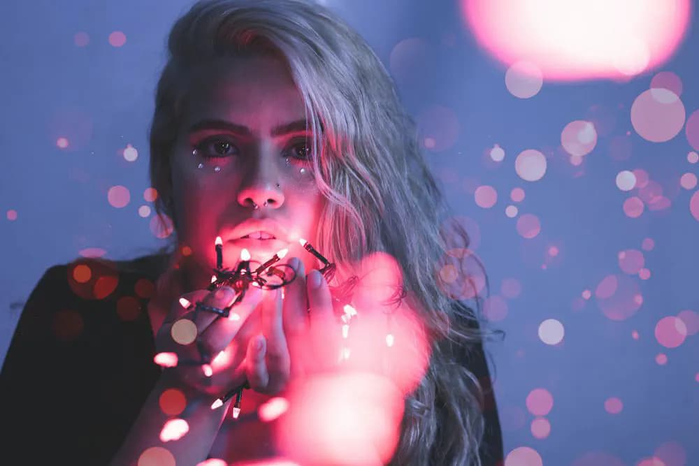 Portrait with coloured fairy lights. Photo: Joao Victor Xavier